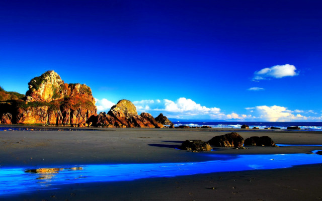 Beach blue water rocks sky free wallpaper for desktop - medium preview image
