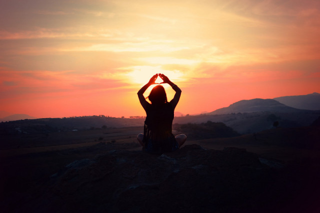 Person sitting hill hands sun free wallpaper for desktop - medium preview image