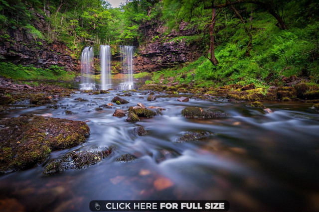 Waterfall rocks foreground forest background free wallpaper for desktop - medium preview image