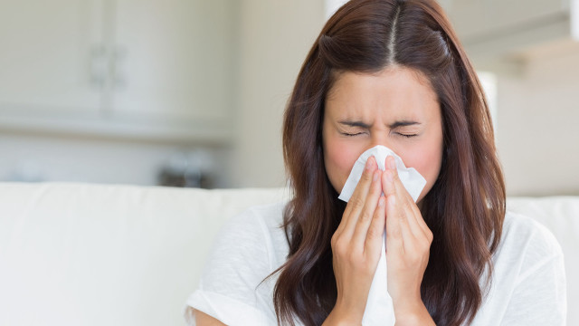 Woman blowing nose tissue couch free wallpaper for desktop - medium preview image