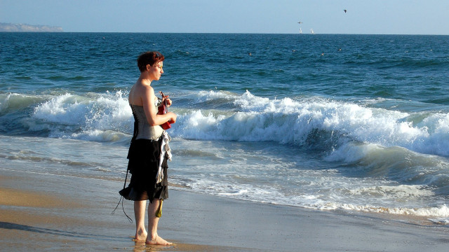 Man beach ocean cellphone microphone free wallpaper for desktop - medium preview image