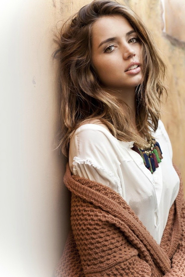 Woman leaning wall sweater necklace free wallpaper for mobile - medium preview image