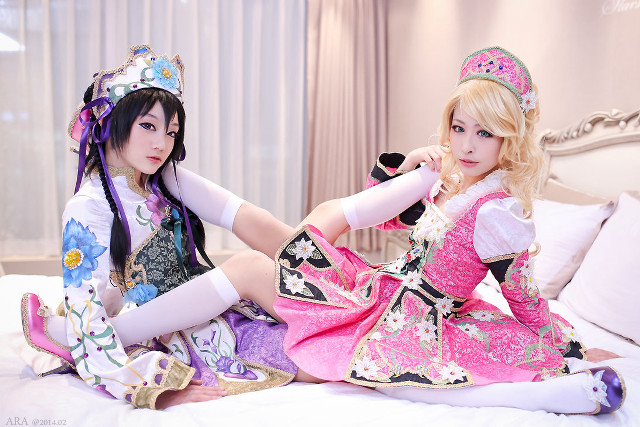 Two women costumes sitting bed free wallpaper for desktop - medium preview image