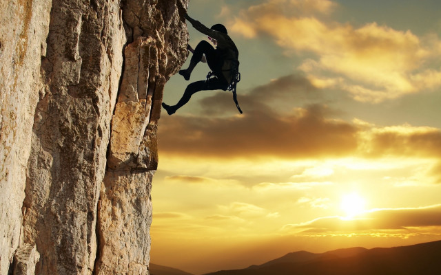 Man climbing cliff sunset backpack free wallpaper for desktop - medium preview image