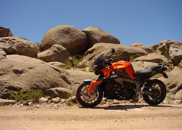 Motorcycle parked rock formation desert free wallpaper for desktop - medium preview image