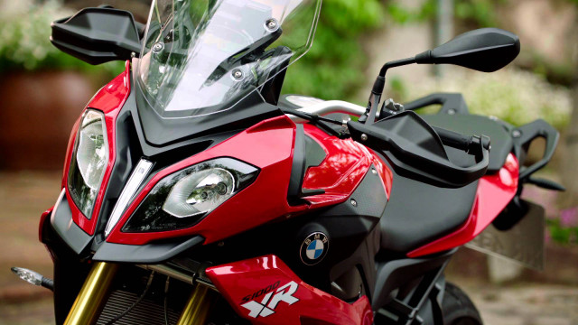 Motorcycle closeup driveway plant background free wallpaper for desktop - medium preview image