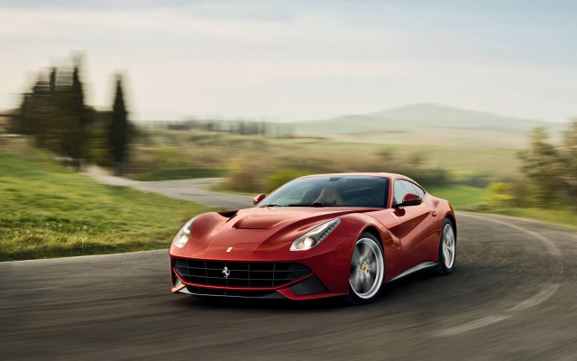 Red sports car driving countryside free wallpaper for desktop - medium preview image