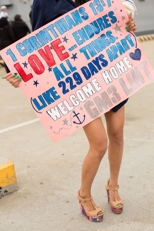 Woman holding sign says love free wallpaper for mobile - medium preview image