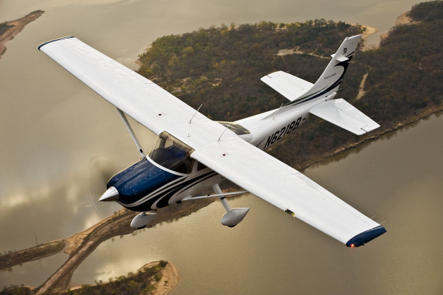 Small airplane flying lake forest free wallpaper for desktop - medium preview image