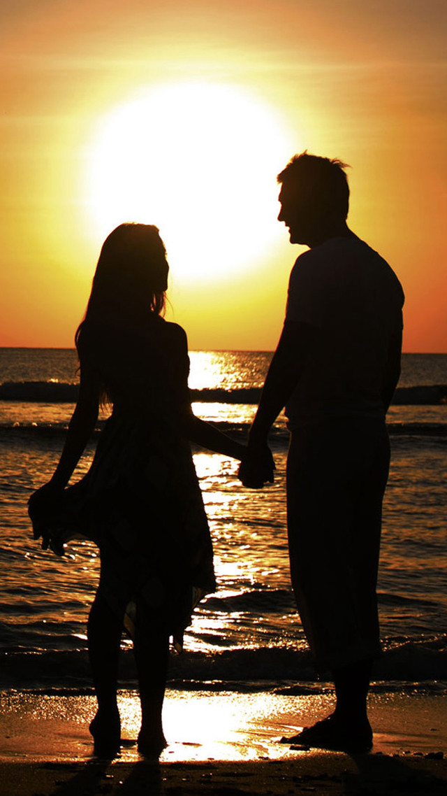 Couple holding hands beach sunset free wallpaper for mobile - medium preview image