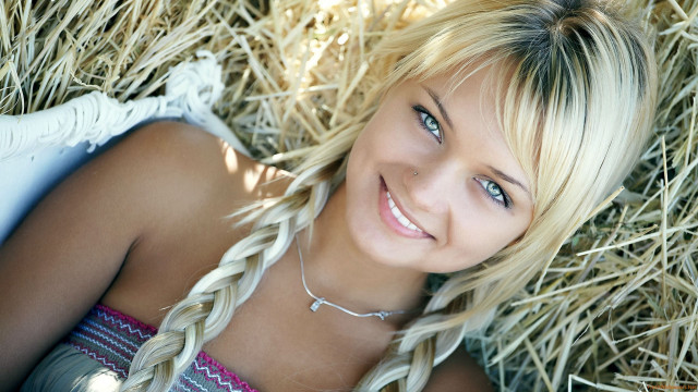 Blond woman laying hay cowgirl free wallpaper for desktop - medium preview image