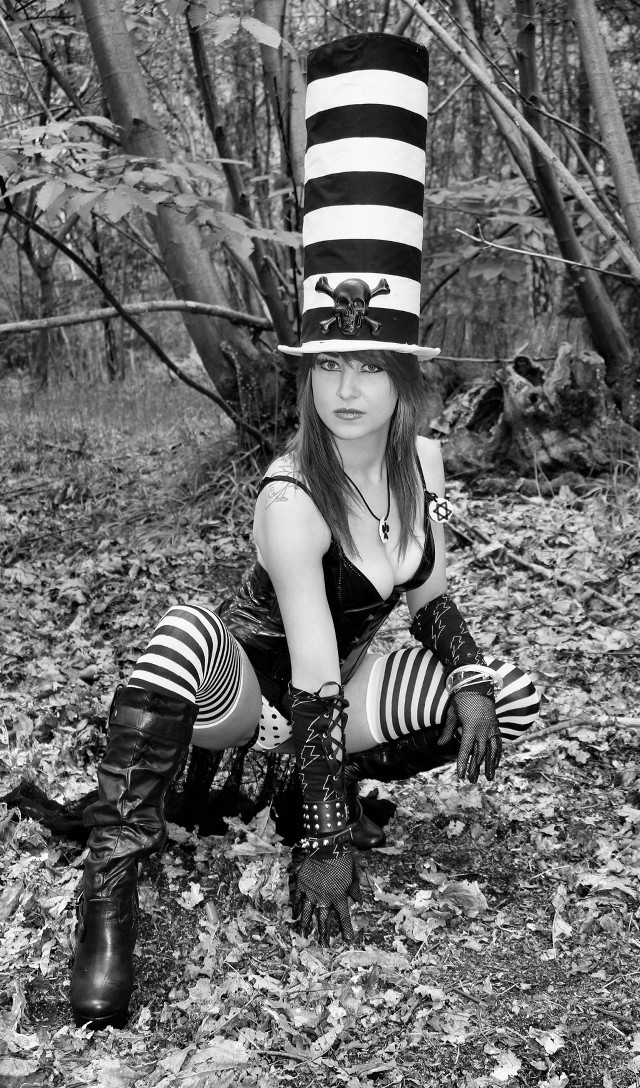 Woman striped hat boots kneeling free wallpaper for mobile - medium preview image