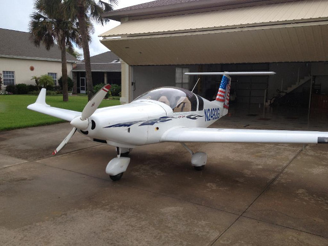 Small airplane parked house flag free wallpaper for desktop - medium preview image