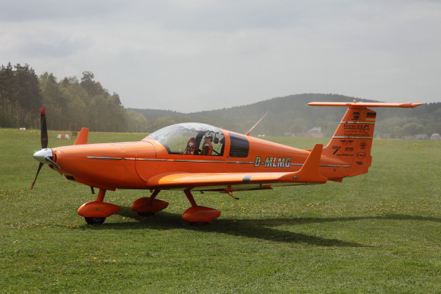 Orange plane green field mountains free wallpaper for desktop - medium preview image