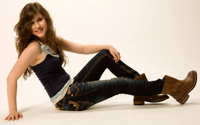 Woman smiling boots jeans sitting free wallpaper for desktop - medium preview image