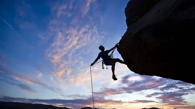 Man climbing cliff rope sunset free wallpaper for desktop - medium preview image