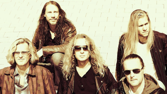 Men sitting brick wall sunglasses free wallpaper for desktop - medium preview image