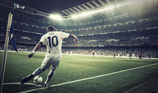 Man kicking soccer ball stadium free wallpaper for desktop - medium preview image