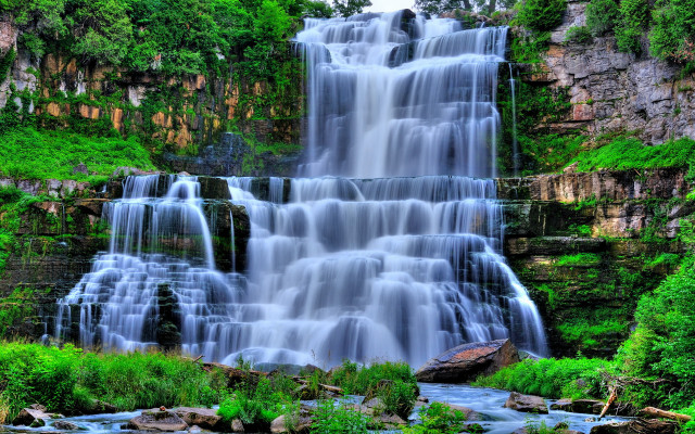 Waterfall cascading lush green forest free wallpaper for desktop - medium preview image