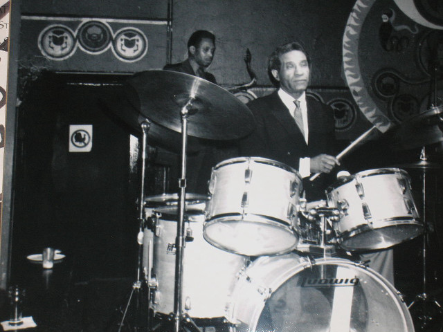 Man suit playing drums room free wallpaper for desktop - medium preview image