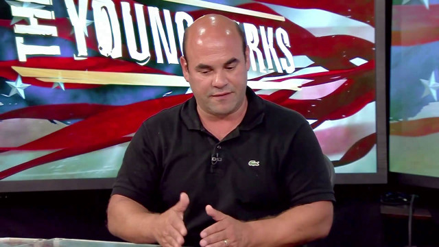 Man black shirt sitting talking free wallpaper for desktop - medium preview image