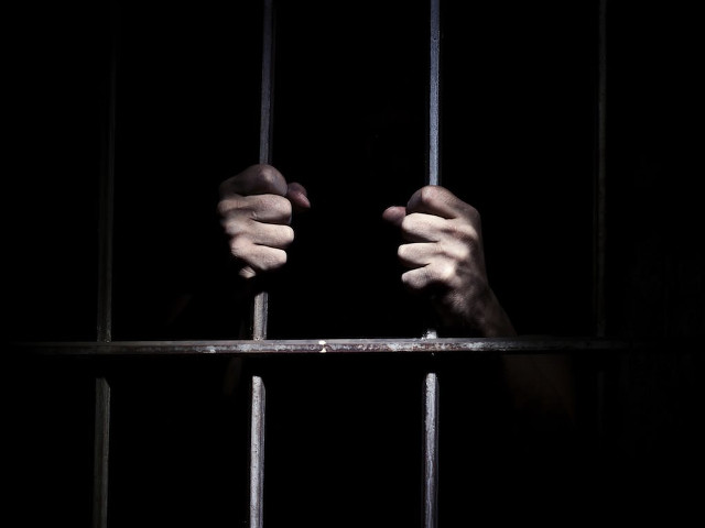 Person holding jail cell hands free wallpaper for desktop - medium preview image