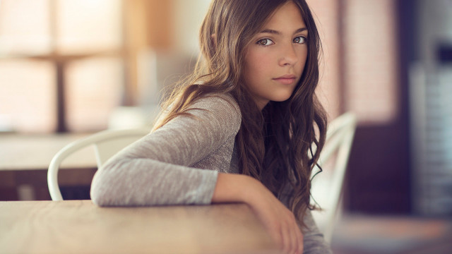 Woman sitting table laptop serious free wallpaper for desktop - medium preview image