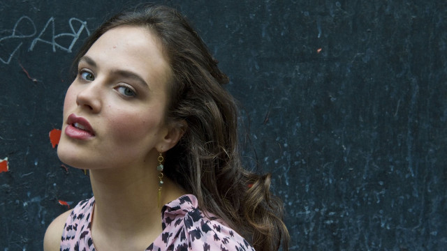 Woman pink shirt black background free wallpaper for desktop - medium preview image