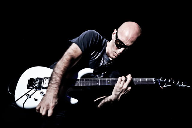 Bald man guitar dark hands free wallpaper for desktop - medium preview image