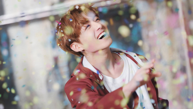 Boy laughing throwing confetti wall free wallpaper for desktop - medium preview image