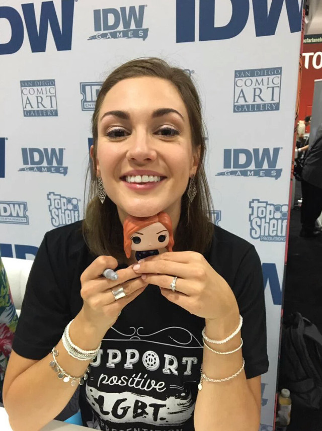 Woman holding cell phone smiling free wallpaper for mobile - medium preview image