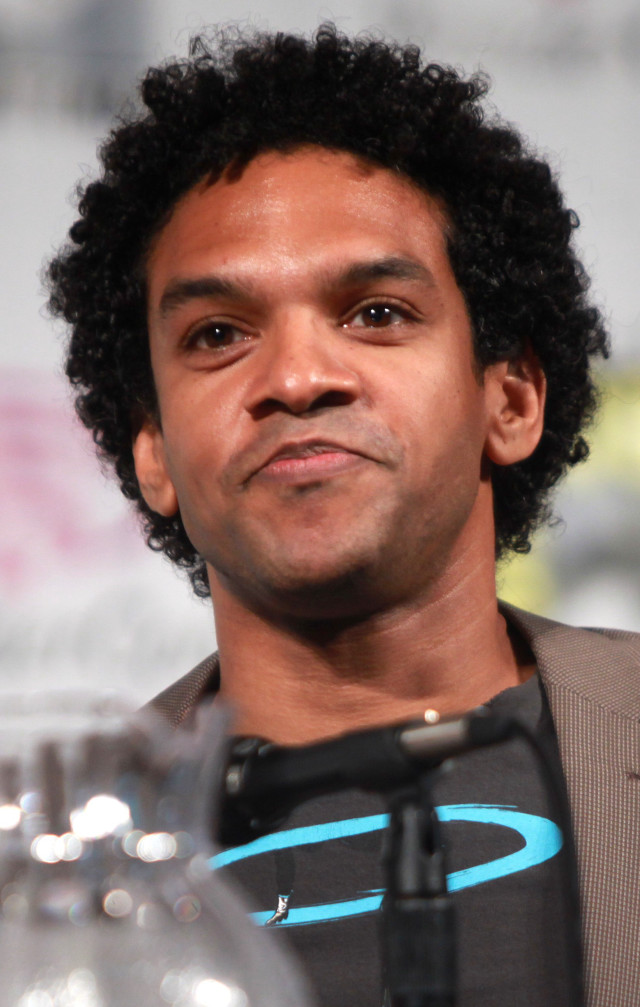 Afrofuturism man blackhair grayjacket water free wallpaper for mobile - medium preview image