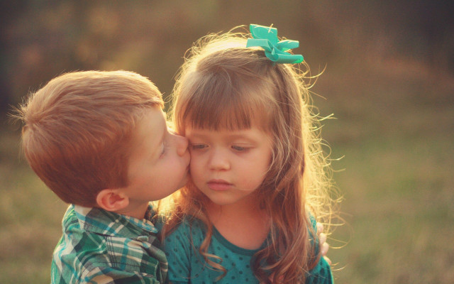 Boy girl kissing field grass free wallpaper for desktop - medium preview image