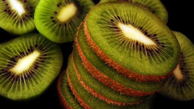 Kiwi slices stacked black surface free wallpaper for desktop - medium preview image