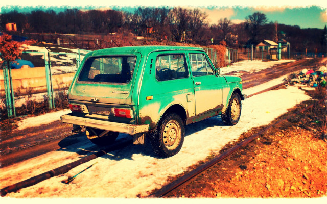 Small green car snowy road free wallpaper for desktop - medium preview image