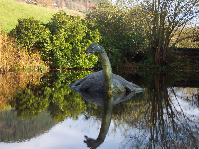 Dinosaur statue lake trees hill free wallpaper for desktop - medium preview image
