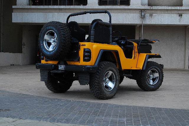 Yellow jeep parked building large free wallpaper for desktop - medium preview image