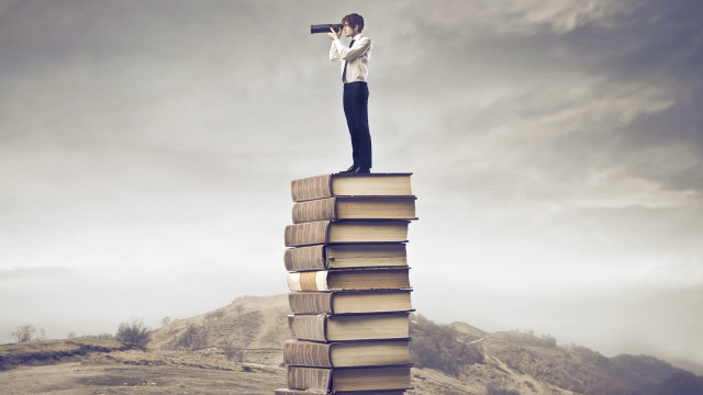 Man standing stack books telescope free wallpaper for desktop - medium preview image