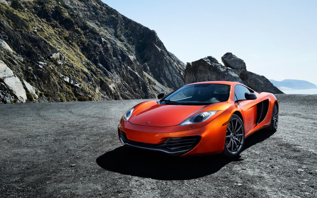 Orange sports car dirt mountain free wallpaper for desktop - medium preview image