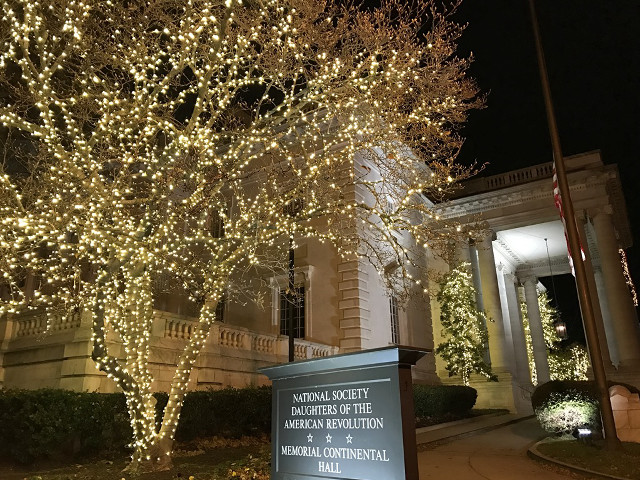 Sign tree lit building night free wallpaper for desktop - medium preview image