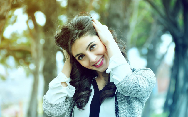 Smiling woman curly hair outdoors free wallpaper for desktop - medium preview image