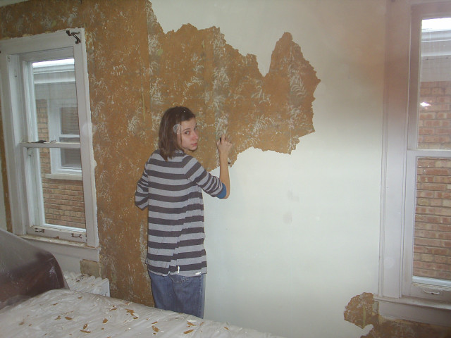 Young boy painting wall brick free wallpaper for desktop - medium preview image