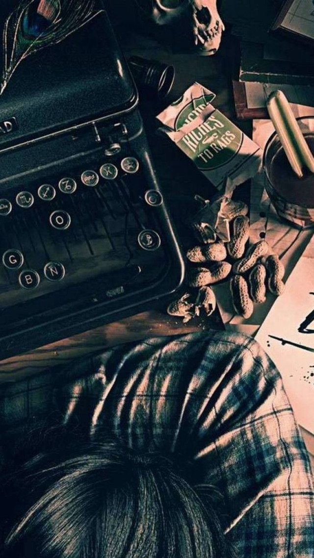 Person laying typewriter book skull free wallpaper for mobile - medium preview image