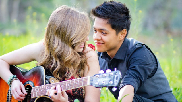 Man woman grass playing guitar #2 free wallpaper for desktop - medium preview image