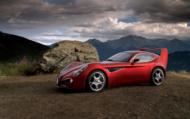 Red sports car mountain rock free wallpaper for desktop - medium preview image
