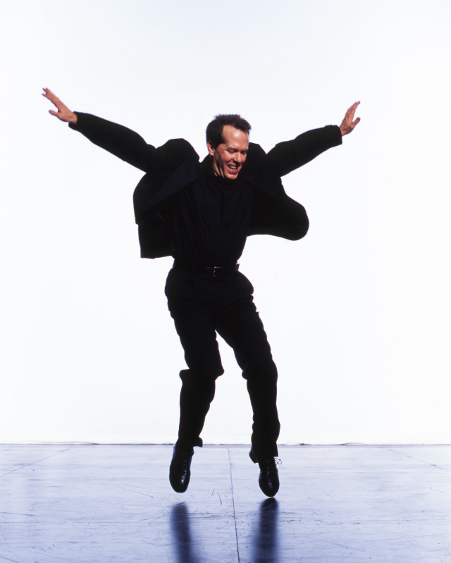 Man jumping black suit outstretched free wallpaper for mobile - medium preview image