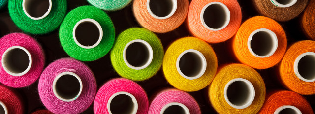 Colorful yarn spools stacked shelf free wallpaper for desktop - medium preview image