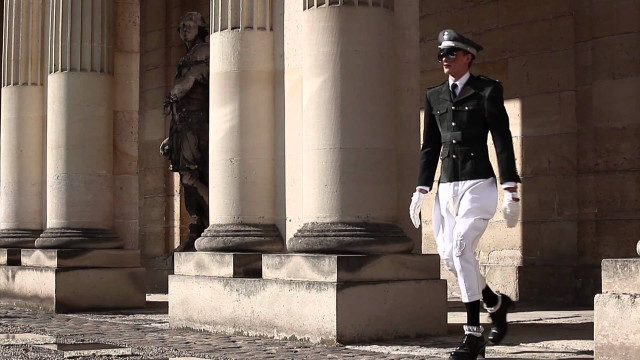 Man uniform walking street columns free wallpaper for desktop - medium preview image