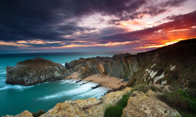 Sunset rocky beach water cliff free wallpaper for desktop - medium preview image