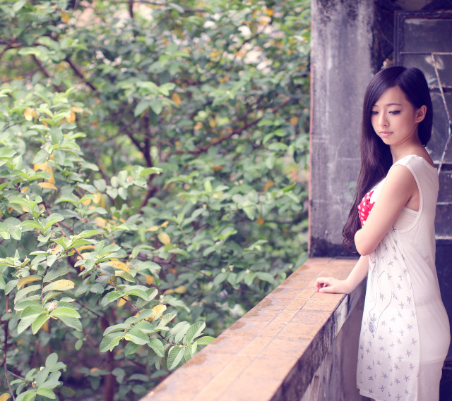 Woman balcony tree bushes hand free wallpaper for tablet - medium preview image